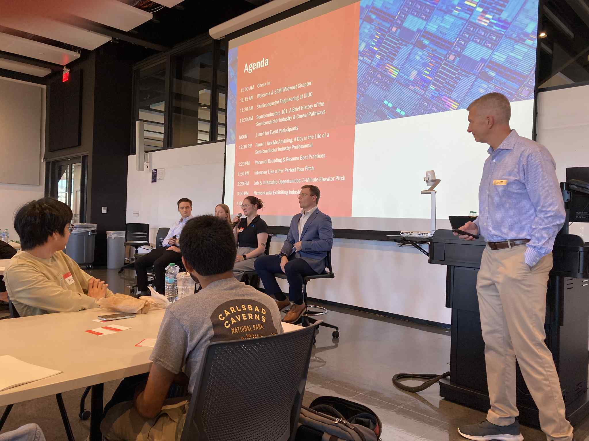 Seminar emcee Andy Stapleton of SEMI Midwest Chapter looks on as panelists share their career stories with students.
