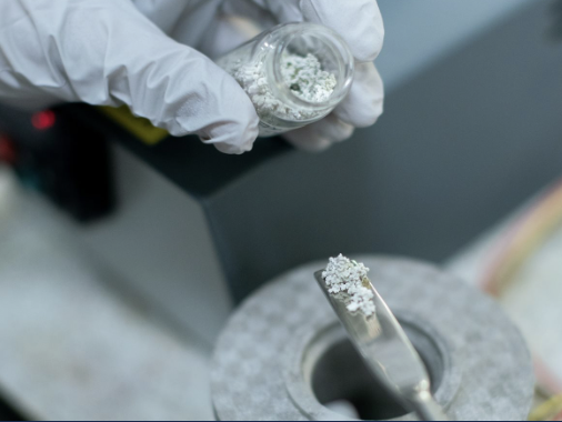 Hands holding materials sample.