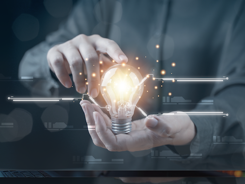 Two hands holding a lightbulb. Research photo.