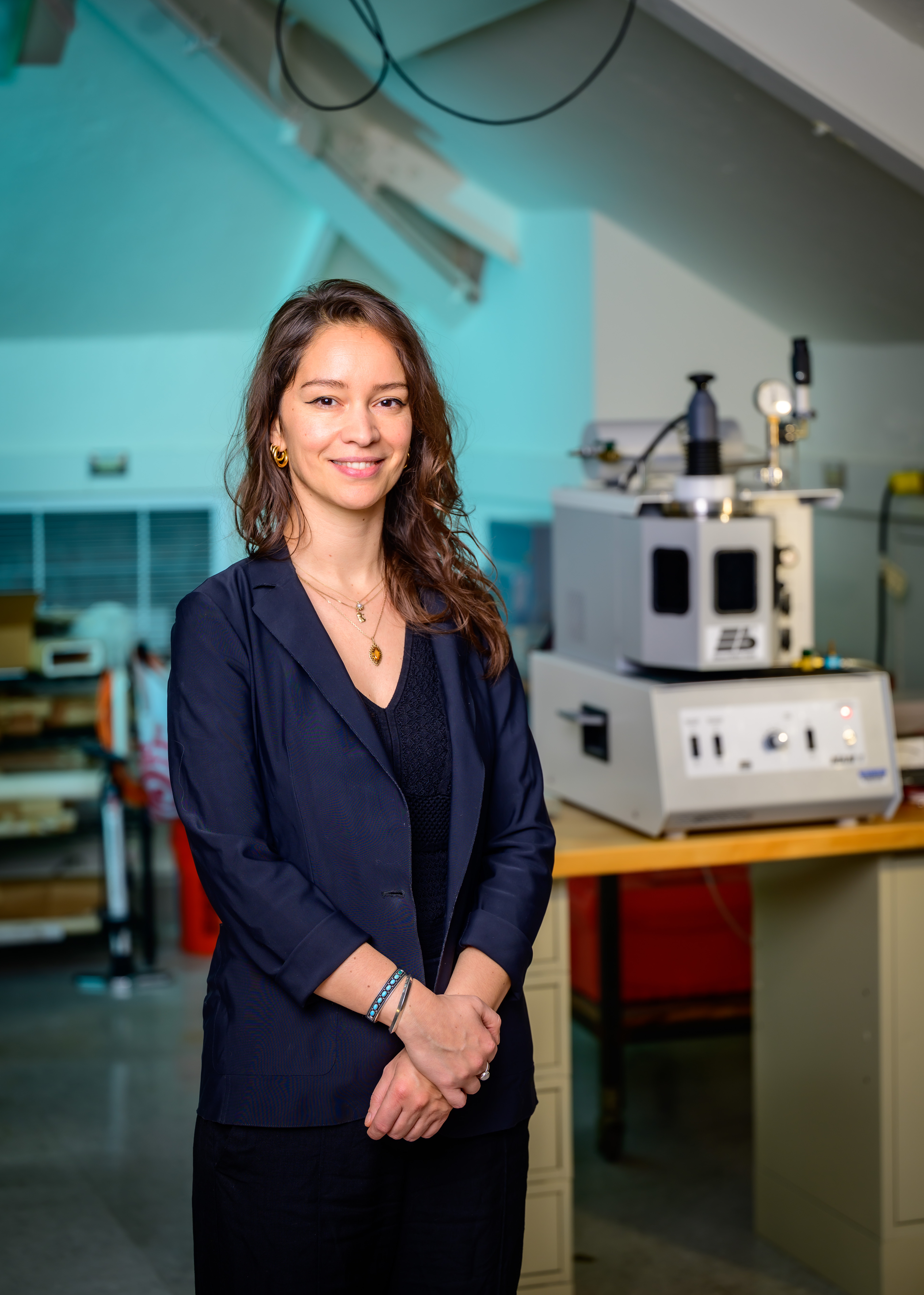 Marie Charpagne standing next to laboratory equipment