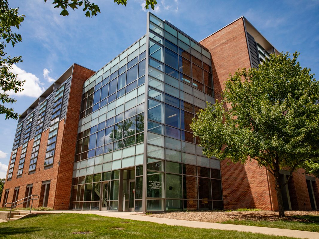 Hands holding histology slides in a lab