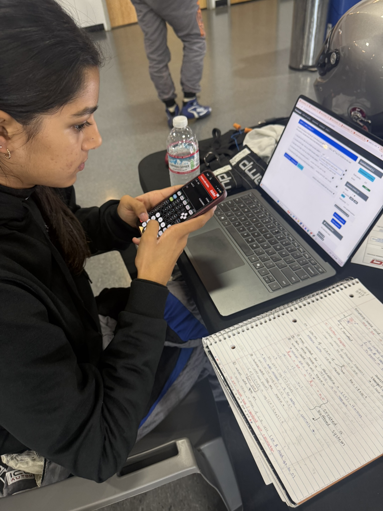 Yana Kapoor holds her phone and uses her laptop while studying in California.