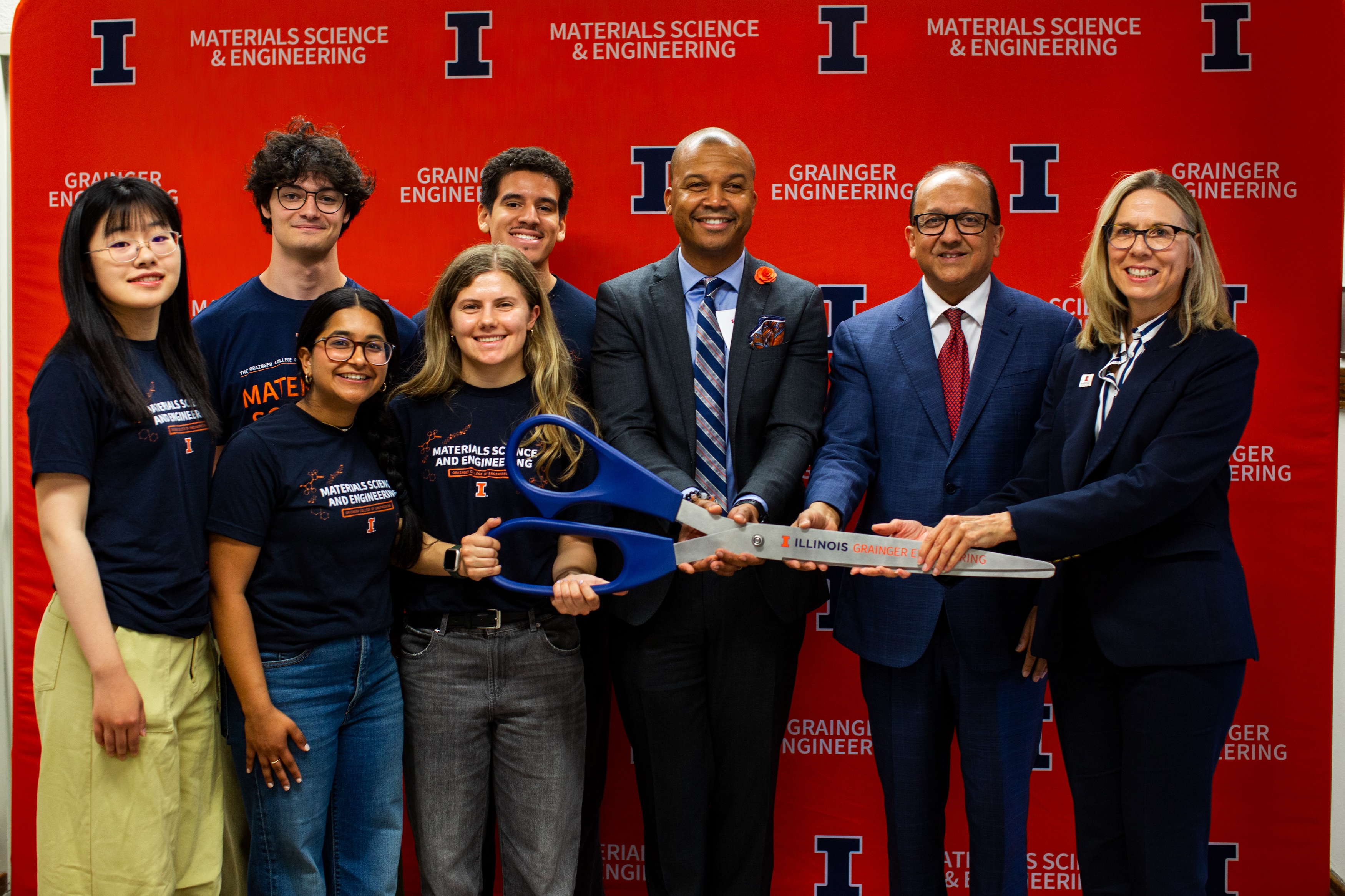 The Eltoukhy Family Innovation Lab student leadership team (left) stands with Vice Chancellor for Advancement Dale Wright, Illinois Grainger Engineering Dean Rashid Bashir and Professor Nancy Sottos with the scissors used to officially open the innovative new student lab space.