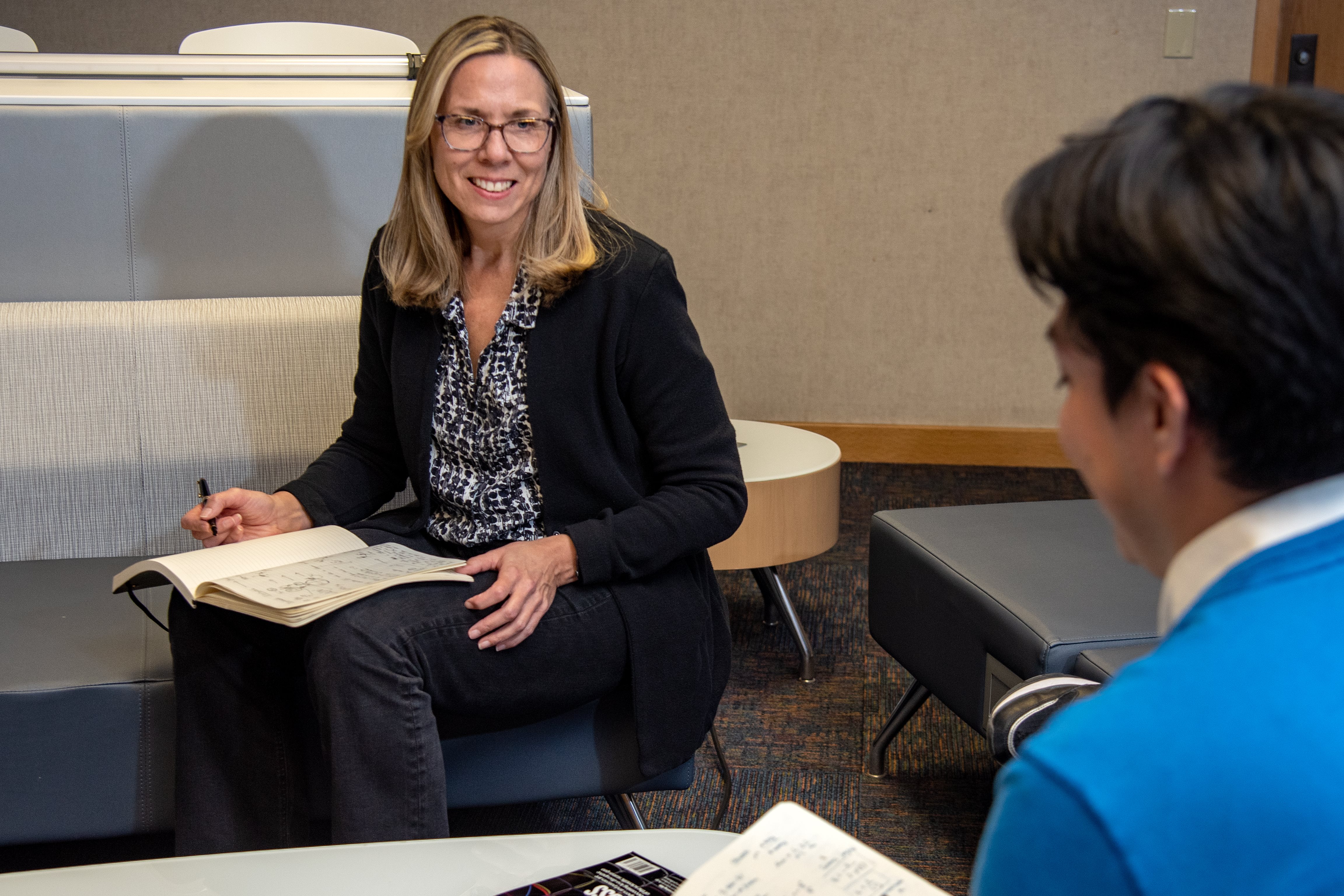 Nancy Sottos smiles while working with a student.