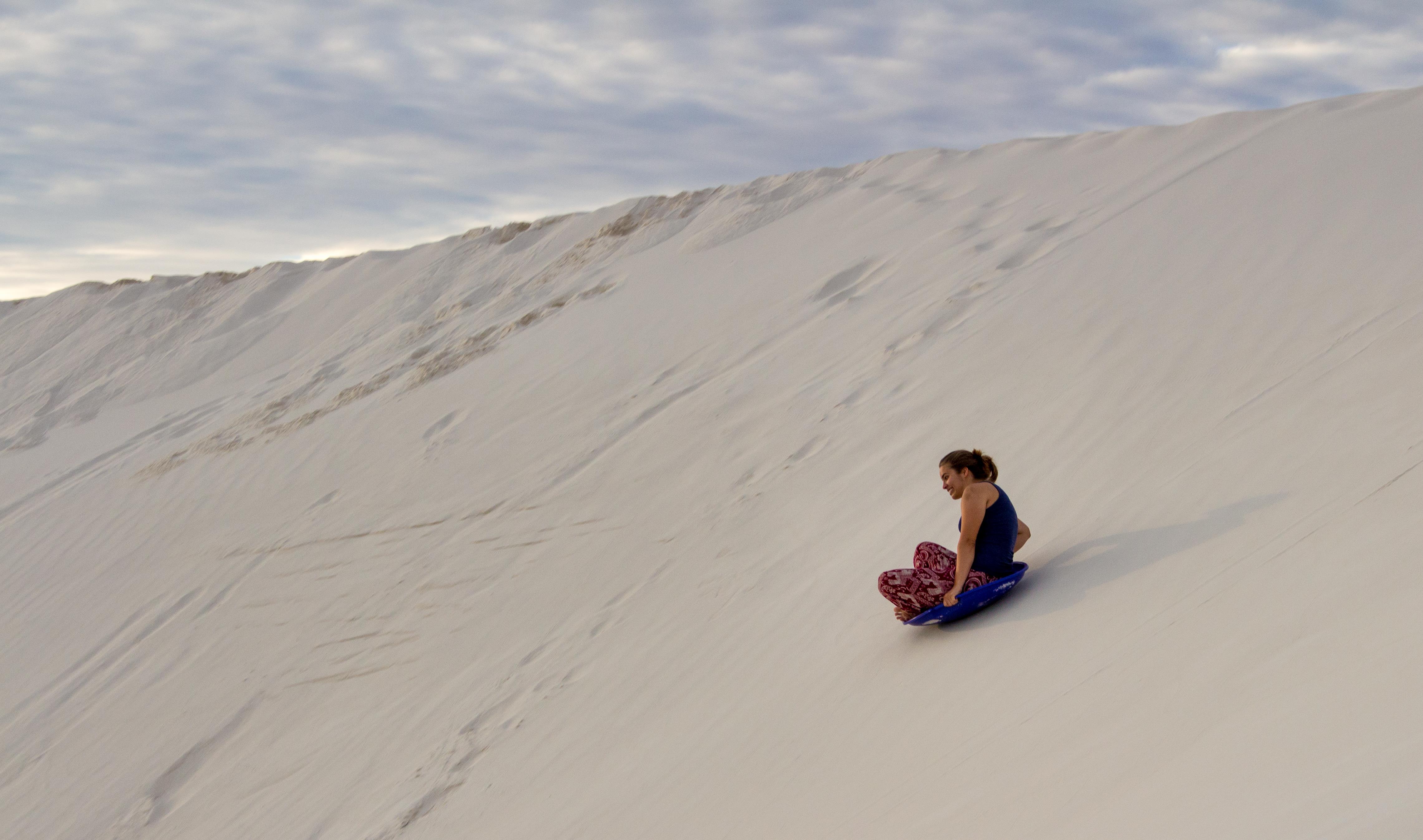 Devon Goszkowicz sliding down sand dune