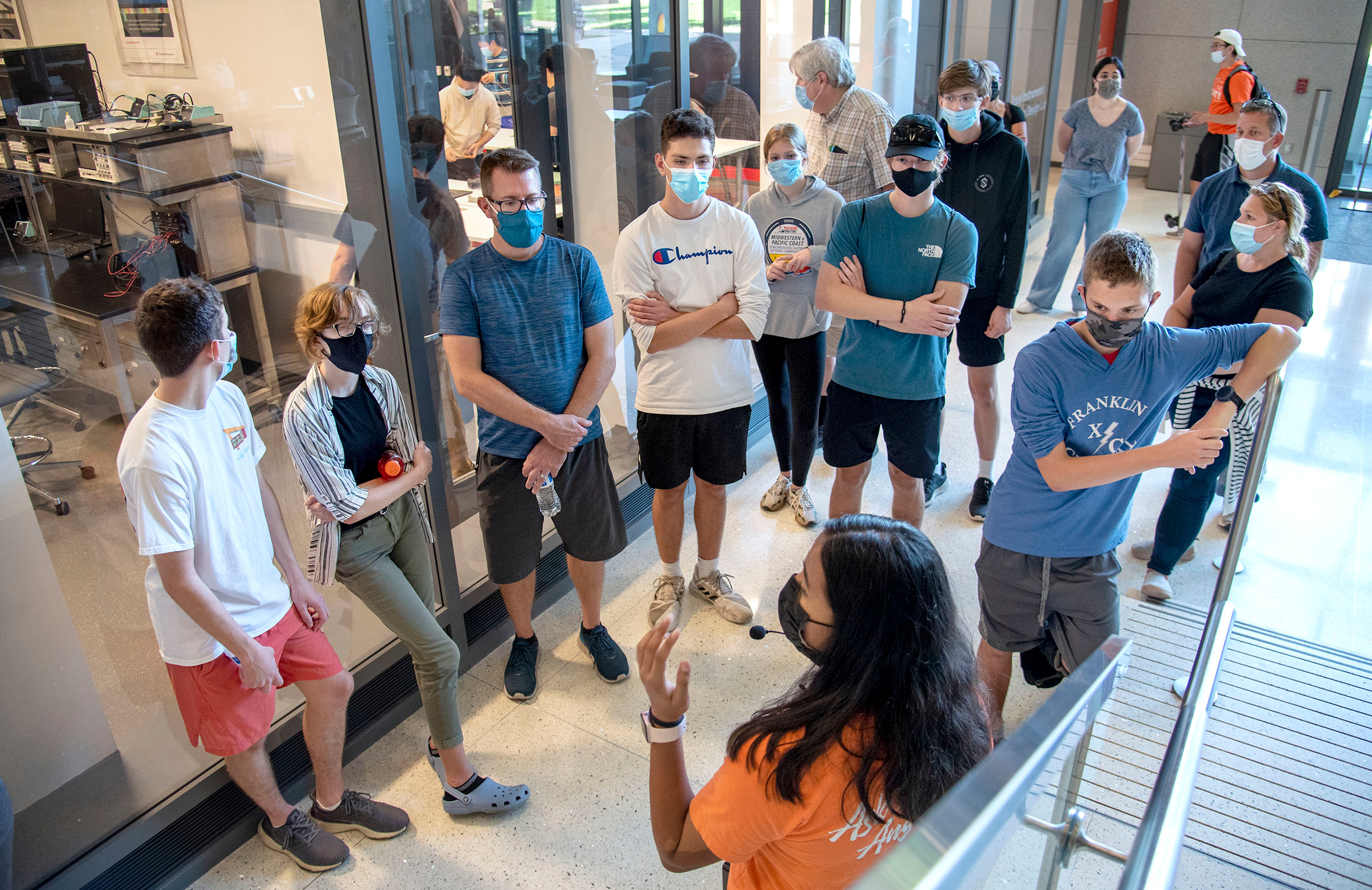 Heather Coit/The Grainger College of Engineering<br /><br />Aishwarya Rajesh, a U of I Department of Electrical Engineering student, leads prospective students and their families on a tour of The Grainger College of Engineering campus on Oct. 12. The Engineering Tour Guide Program offers 20-plus tours a month to 4,000-plus visiting students and their families, which adds up to 1,800-plus hours of walking across Bardeen and North Quads and selected buildings, labs and classroom spaces.