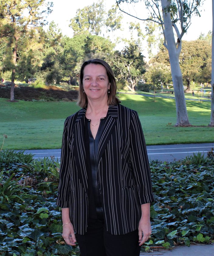 Julie Schoenung poses for a photo looking out at Aldrich Park in the center of the University of California, Irvine campus. &quot;It&rsquo;s our equivalent of the quad,&quot; Schoenung said, &quot;but it&rsquo;s a circle.&quot; UCI's materials science and engineering department is in Engineering Tower is located near the park.