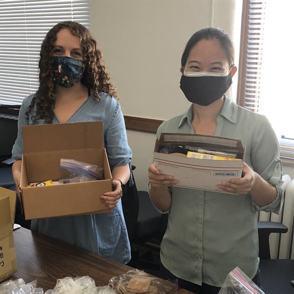 Emiliana Cofell, left, a MatSE at Illinois graduate student, helps professor Pinshane Huang pack and send boxes of sample material experiment kits to prospective Fall 2020 students at the Materials Science and Engineering Building earlier in 2020.