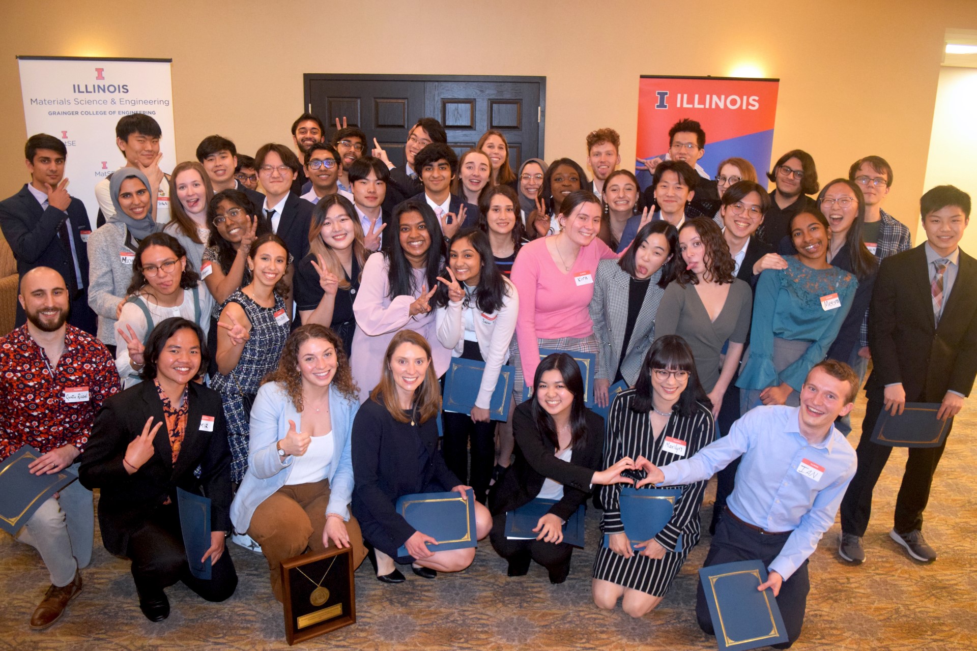 MatSE undergraduate and graduate award-winners take part in a silly group photo to celebrate the Spring 2022 Awards Banquet at the Holiday Inn in Champaign, Ill. on April 21.