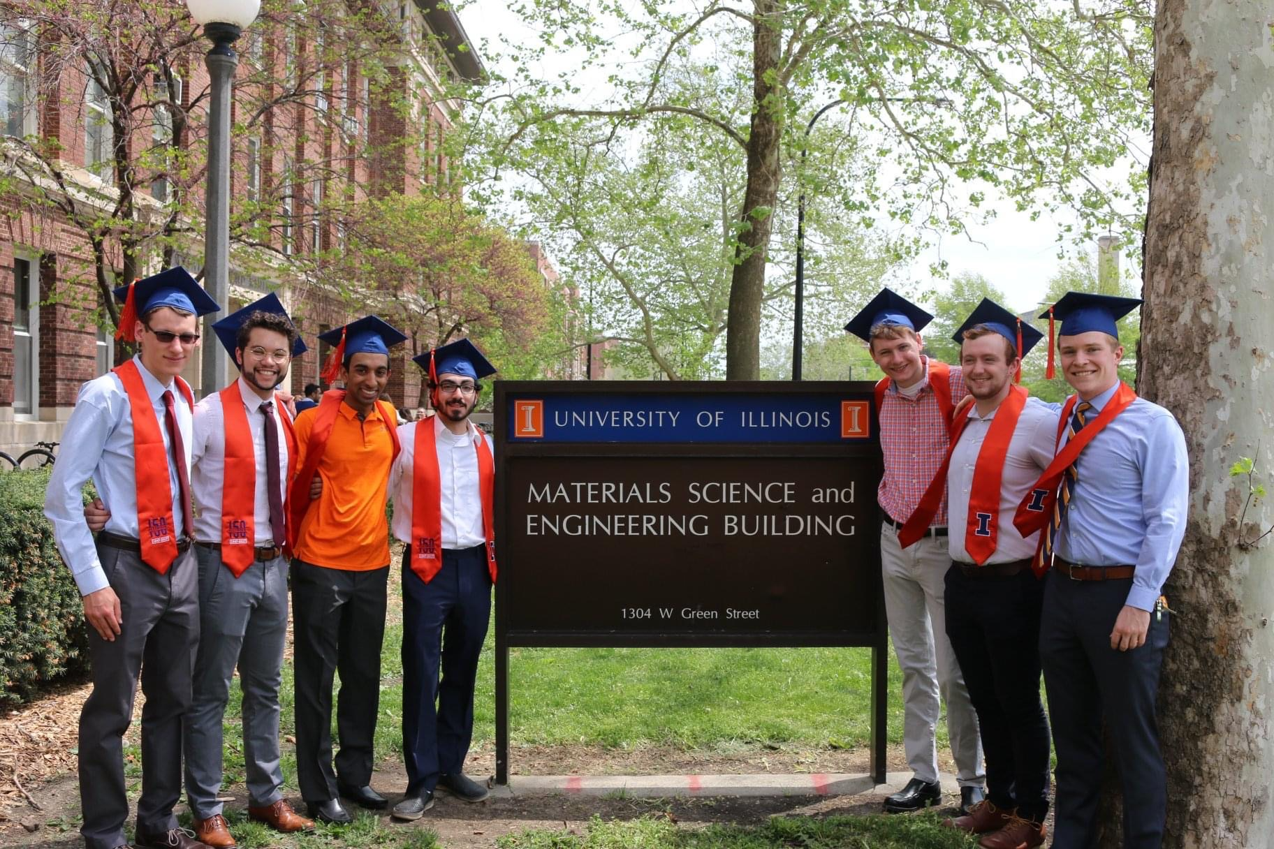 Kyle McKillop, right, is all smiles with his MatSE Class of 2018 peers outside the Materials Science and Engineering Building on Green Street in Urbana, Ill.