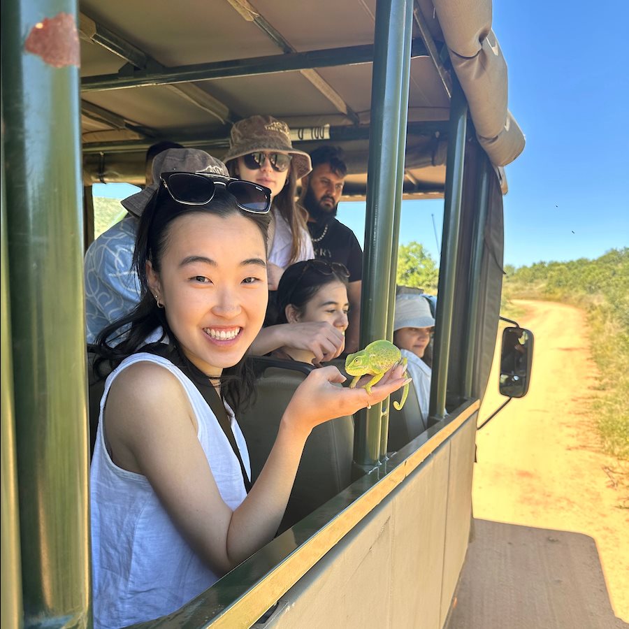 Meghan Oh can't help but smile while holding a chameleon while on a safari tour through Pilanesberg National Park in South Africa.