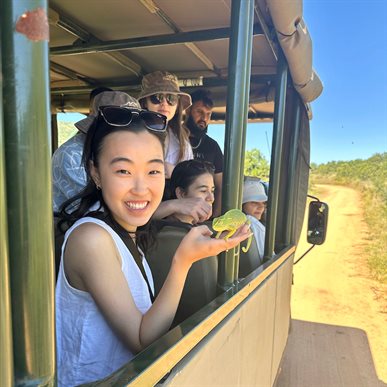 Meghan Oh can't help but smile while holding a chameleon while on a safari tour through Pilanesberg National Park in South Africa.