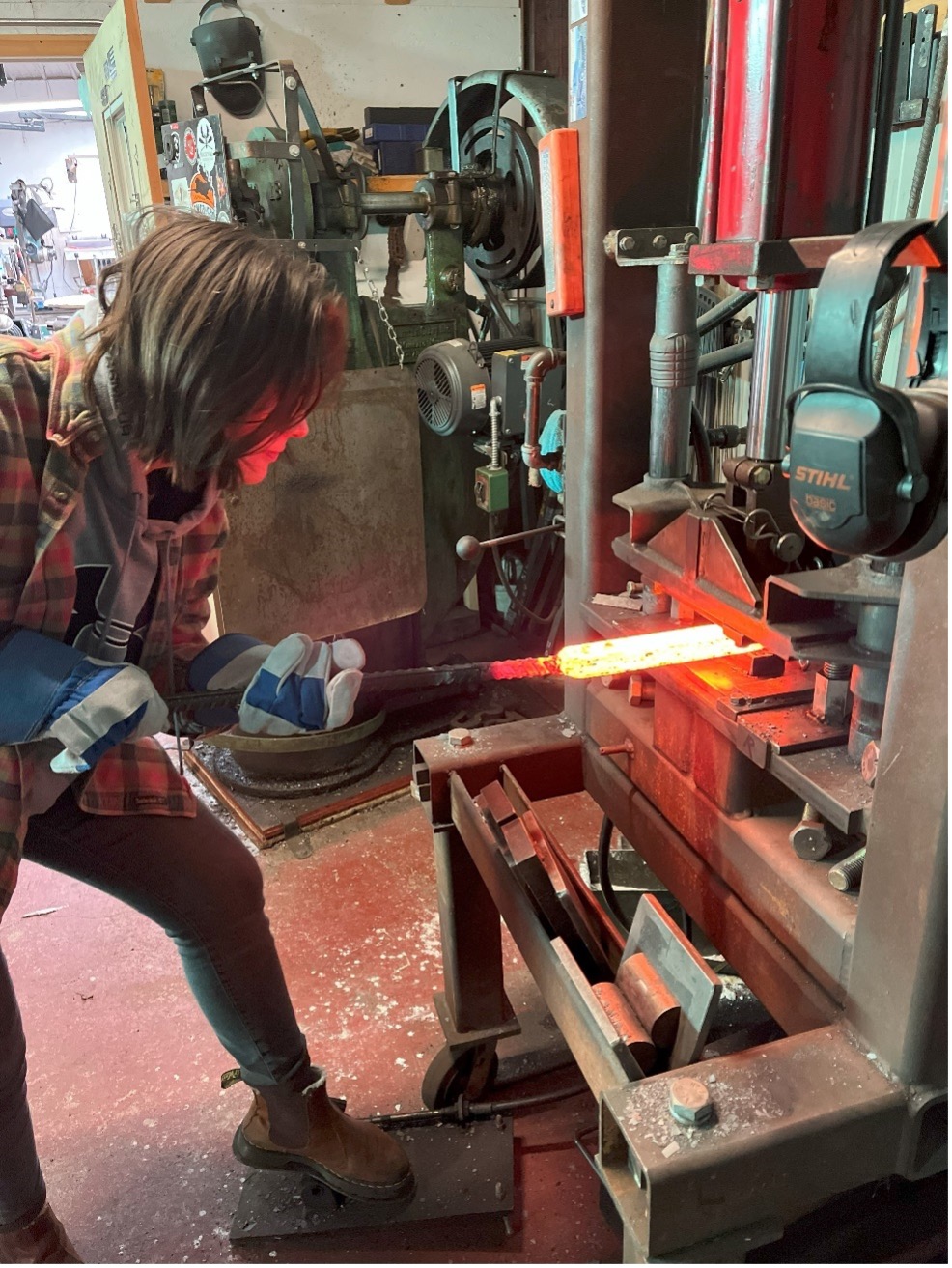 Kira Martin works on the Damascus blade at the Andersen Forge workshop in Watseka, Ill.