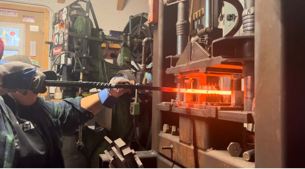 MatSE undergrad Abby Sreden shapes the Damascus blade at the Andersen Forge workshop in Watseka, Ill.