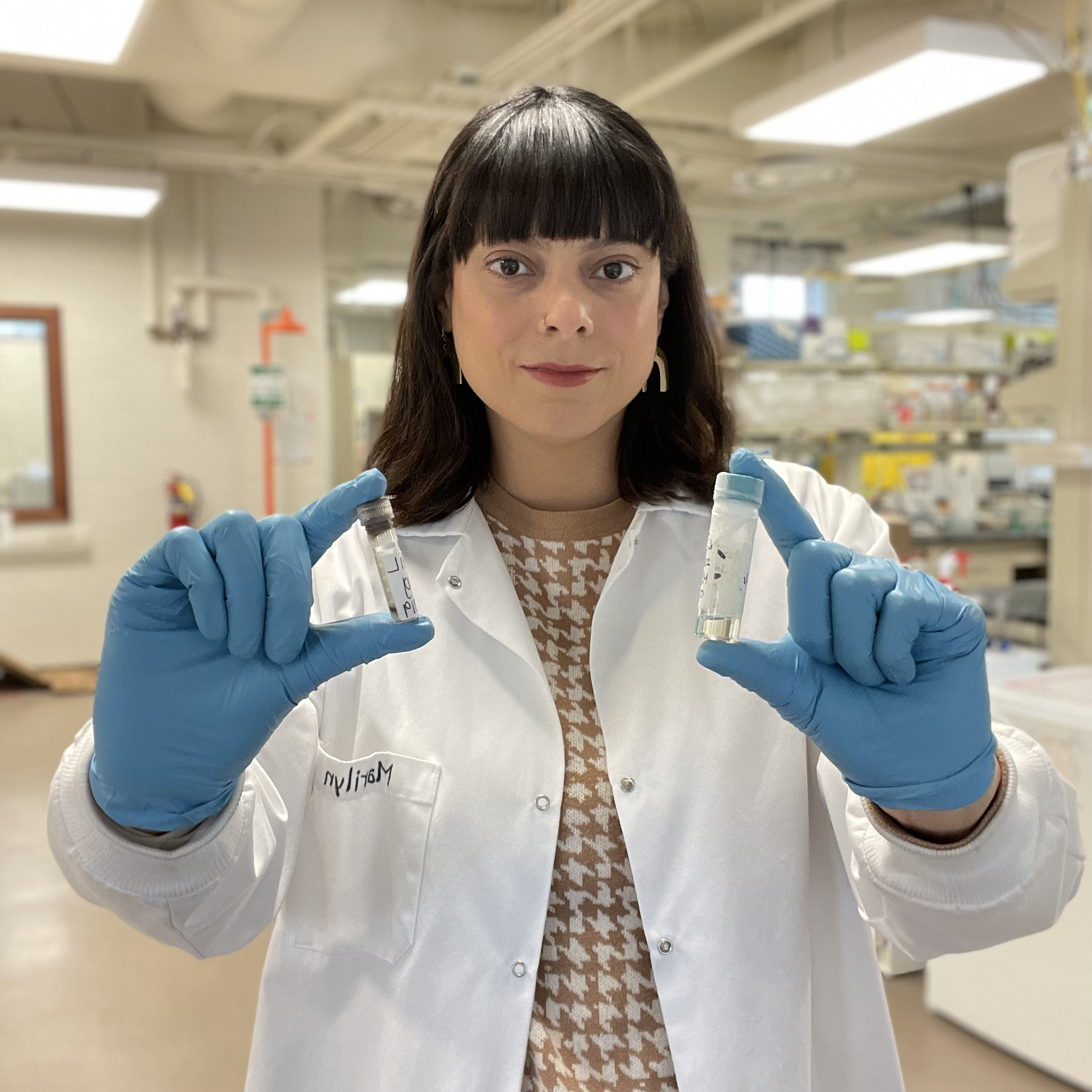 Marilyn Porras-Gomez holding vials of tissue.