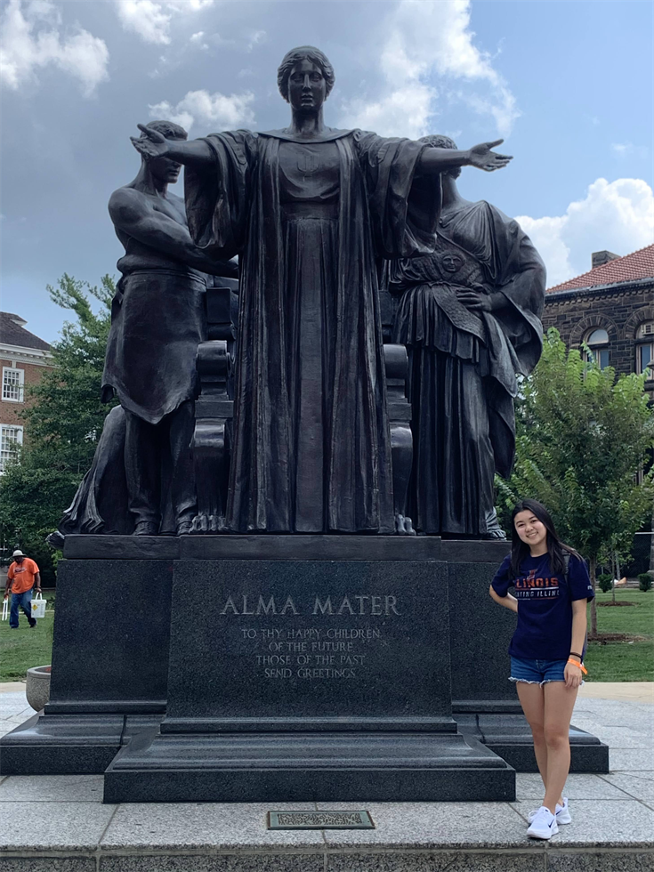 Kayla Huang poses for a photo in front of Alma Mater in Urbana, Ill.