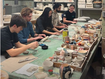 Undergraduates participate in the Play with Clay event in the basement of Illinois' Ceramics Building in Urbana, Ill. Pictured, from left, are Henry Beaulieu, Hayden Gantt, Alice Gao, Aniket Kahanna and Nicole Poppe.