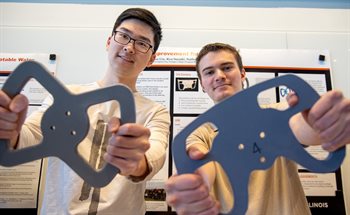 MatSE seniors Haoran Liu, left, and Nathan Levandovsky show off their redesigned steering wheel for the Off-Road Illini team during the annual presentation day held at the Campus Instructional Facility in Urbana, Ill. on May 5.
