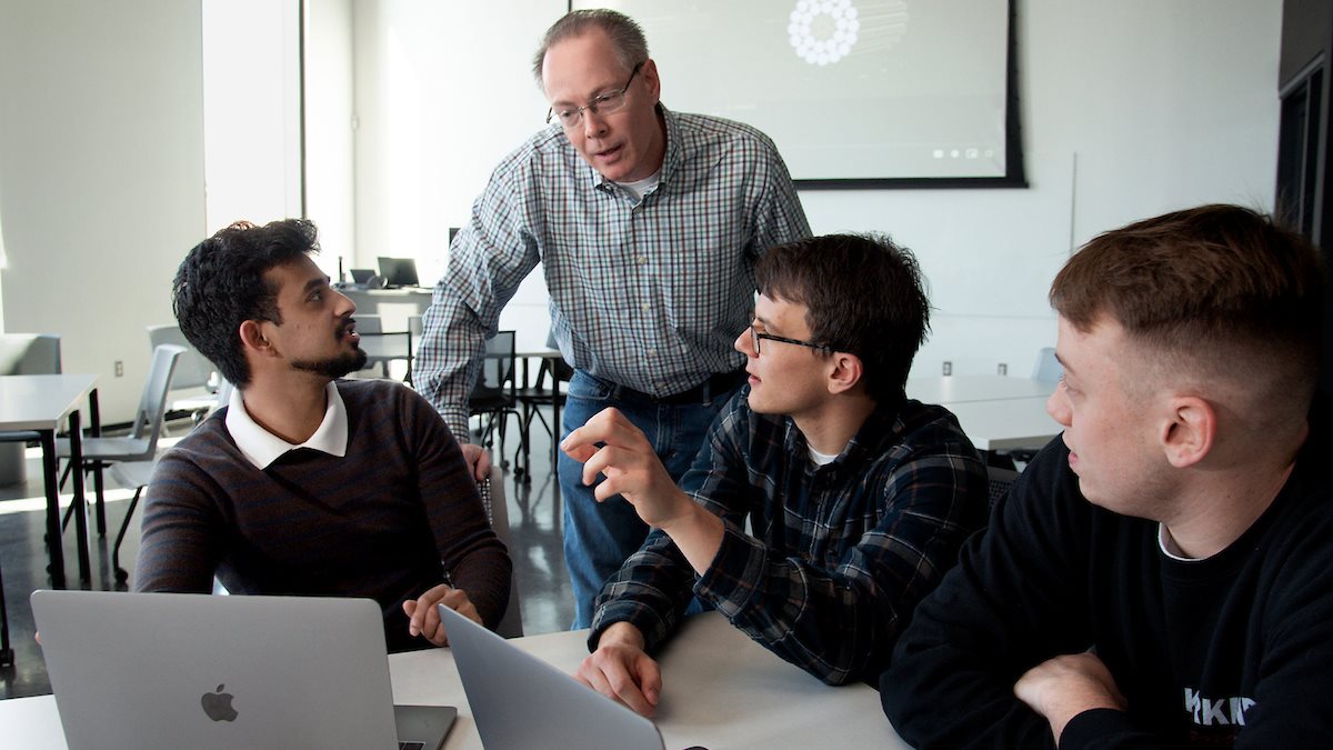 3M senior staff scientist and MatSE alum Matt Frey, second from left, chats with the MatSE students he mentored during the spring 2023 semester at the Campus Instructional Facility earlier in April. MatSE students pictured, from left, are: Akshay Subramani , Alexandru Grindeanu and Alex Meindl.