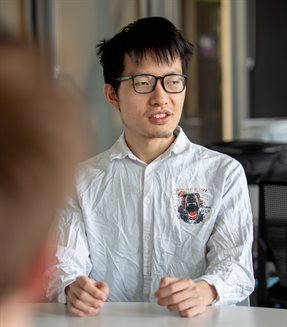 Xianyang Chen chats with his Senior Design teammates during the annual presentation day at the Campus Instructional Facility in Urbana, Ill. on May 5.