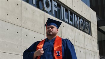 Isiah Ramos stands proudly at Illinois graduation