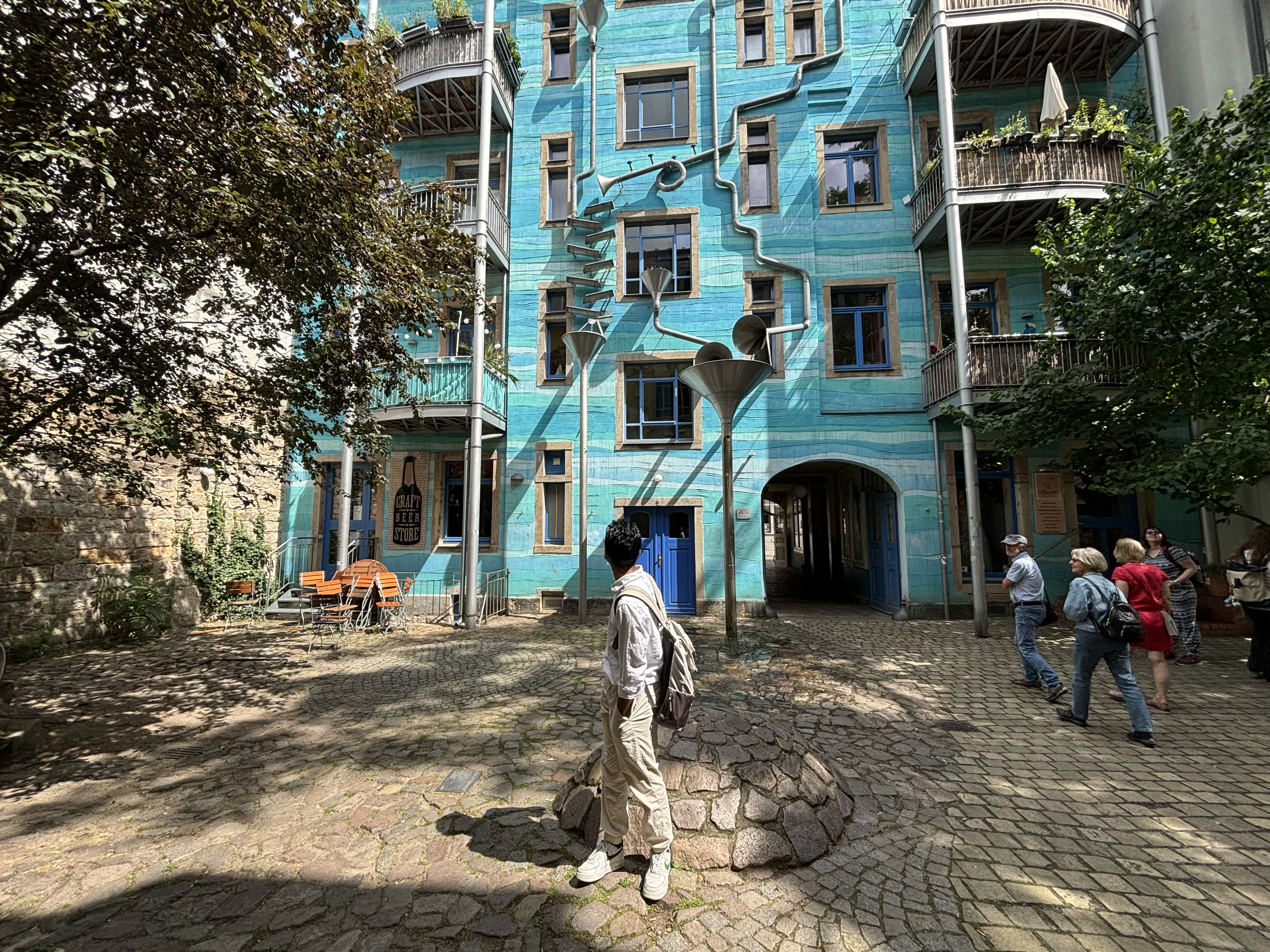 Shivansh Agarwal looks up at a residential building while on an overseas research trip.